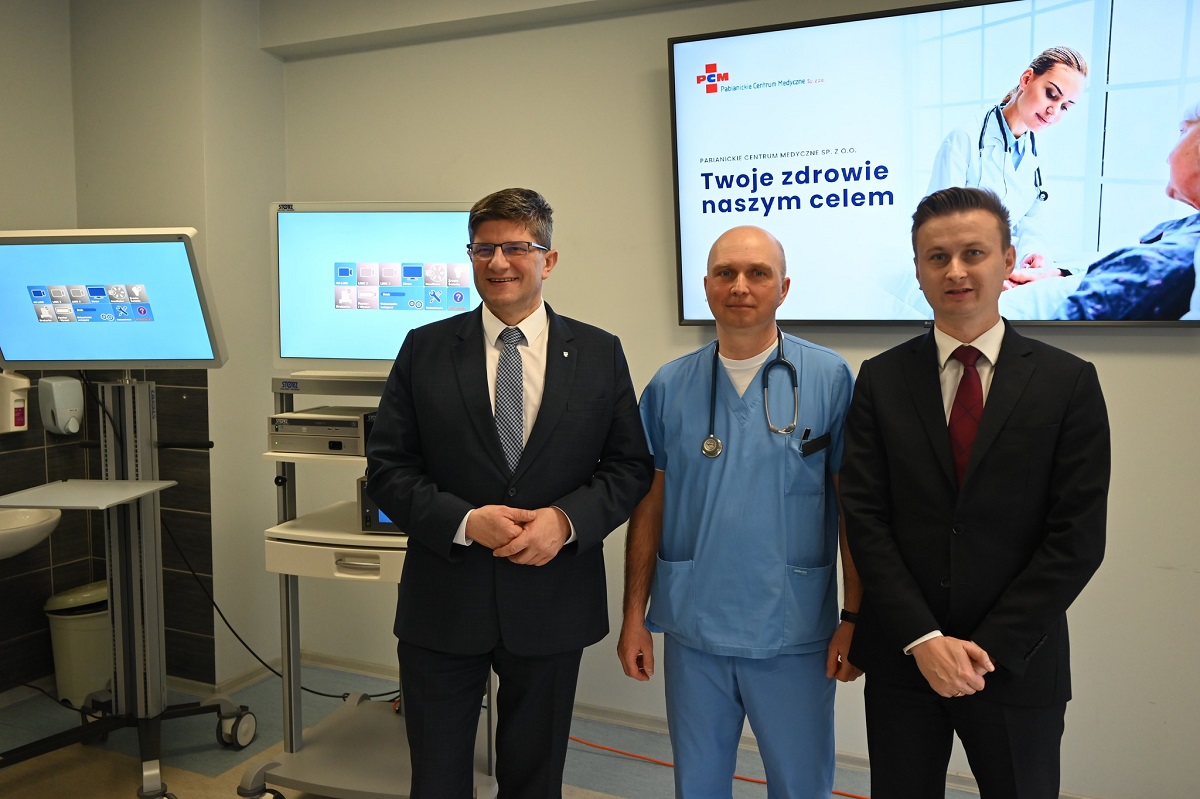 Prezes PCM, kierownik oddziału chirurgii ogólnej i naczyniowej oraz prezydent Pabianic stoją koło laparoskopu.